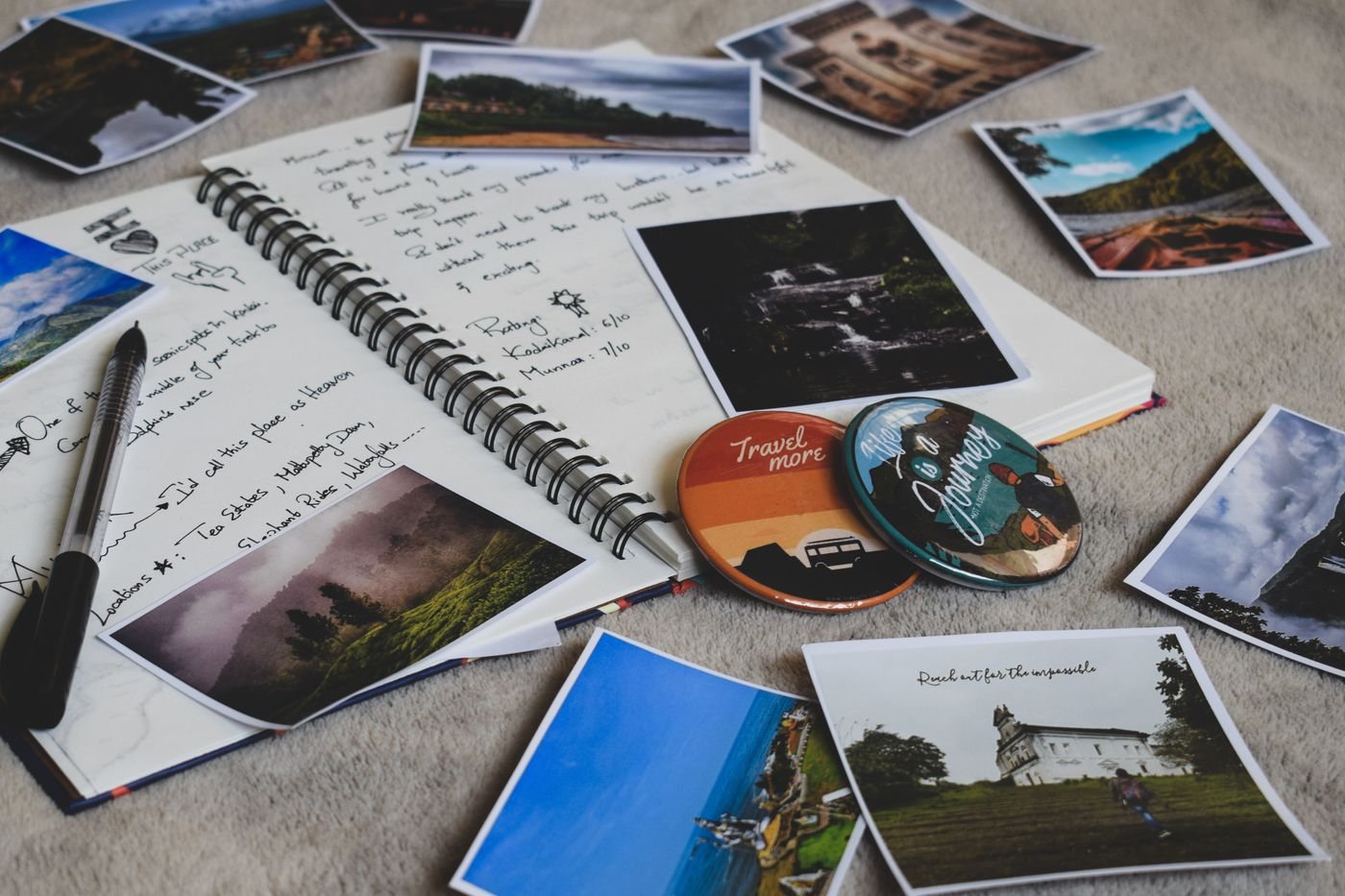 A travel journal surrounded by printed photographs