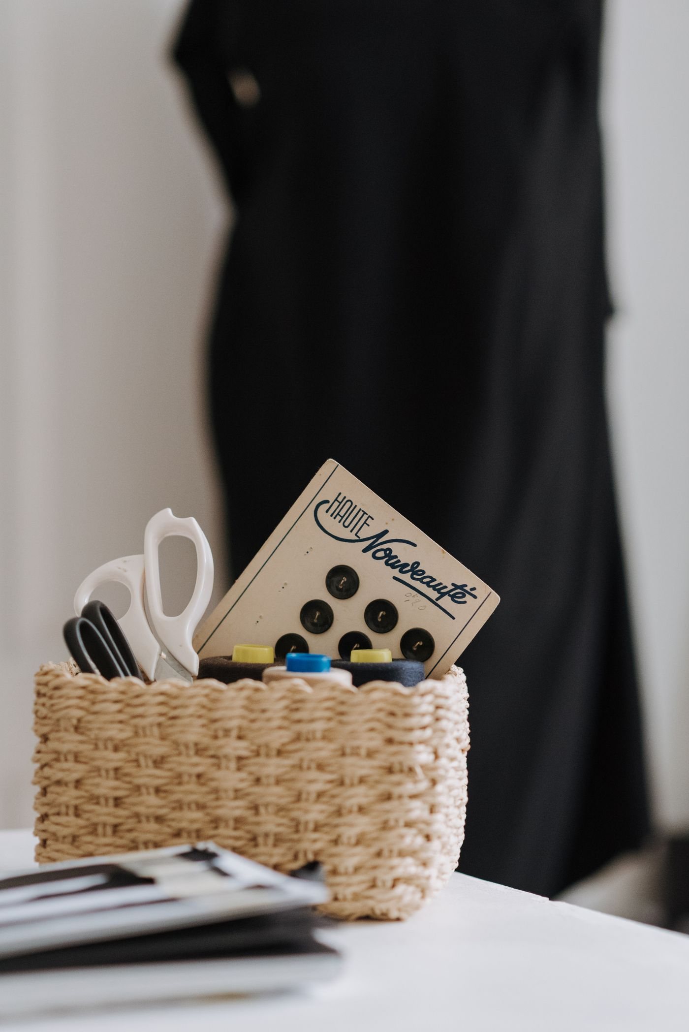 Sewing threads and scissors stored in a basket