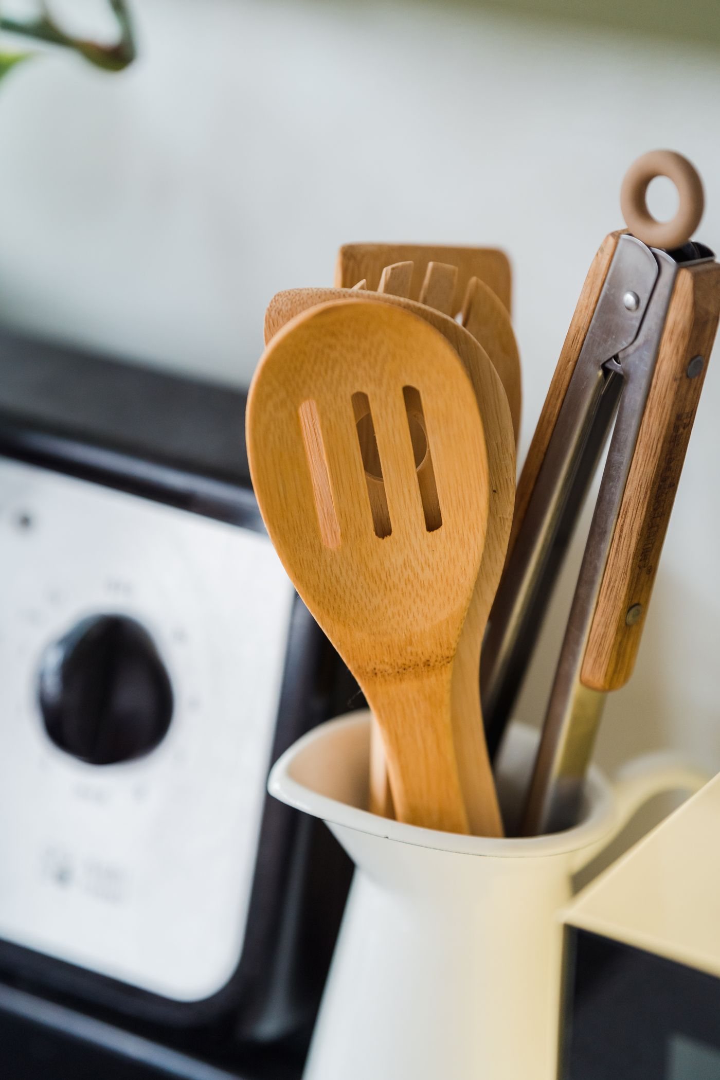 Wooden and metal utensils in a kitchen container
