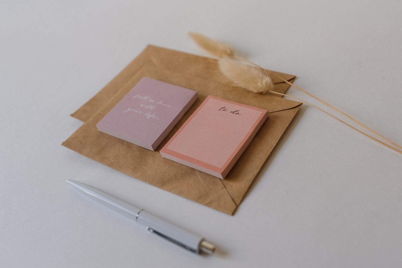 A pen and paper notes arranged with envelopes