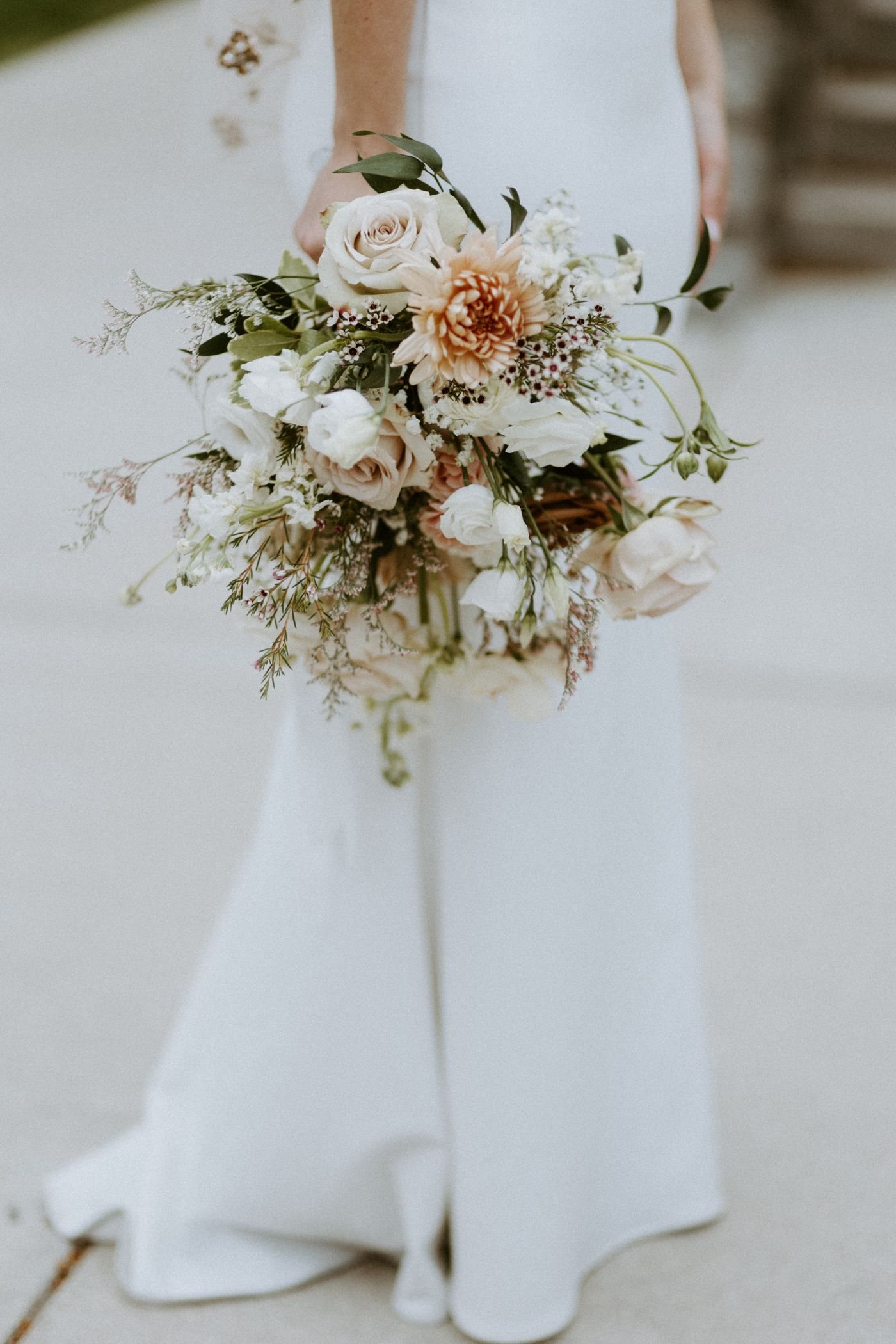 A bride holding a small wedding bouquet