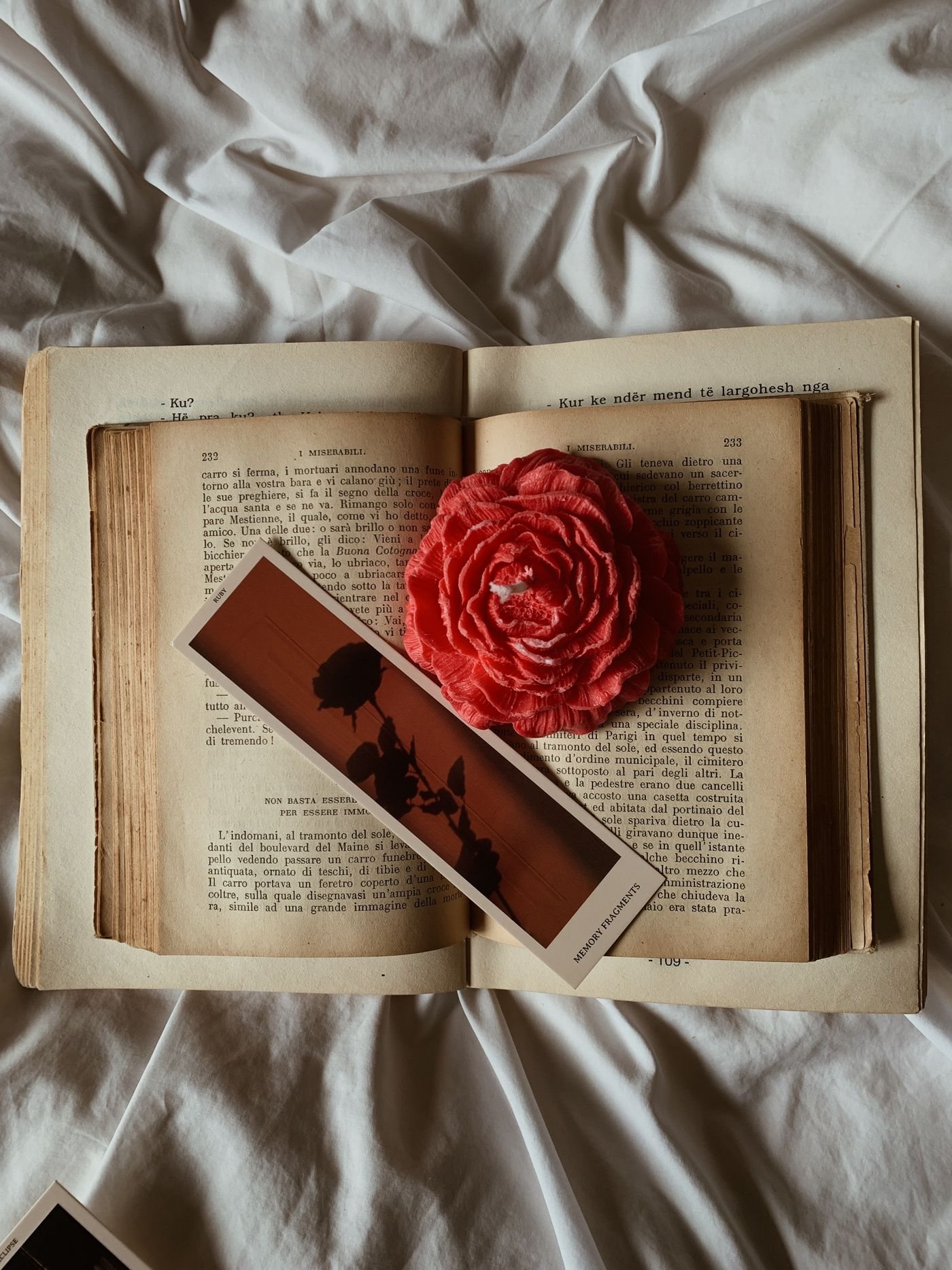 A book and bookmark paired with a single rose