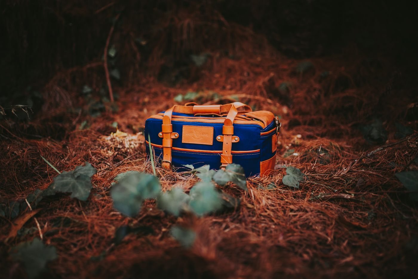 A canvas duffel bag set on the ground