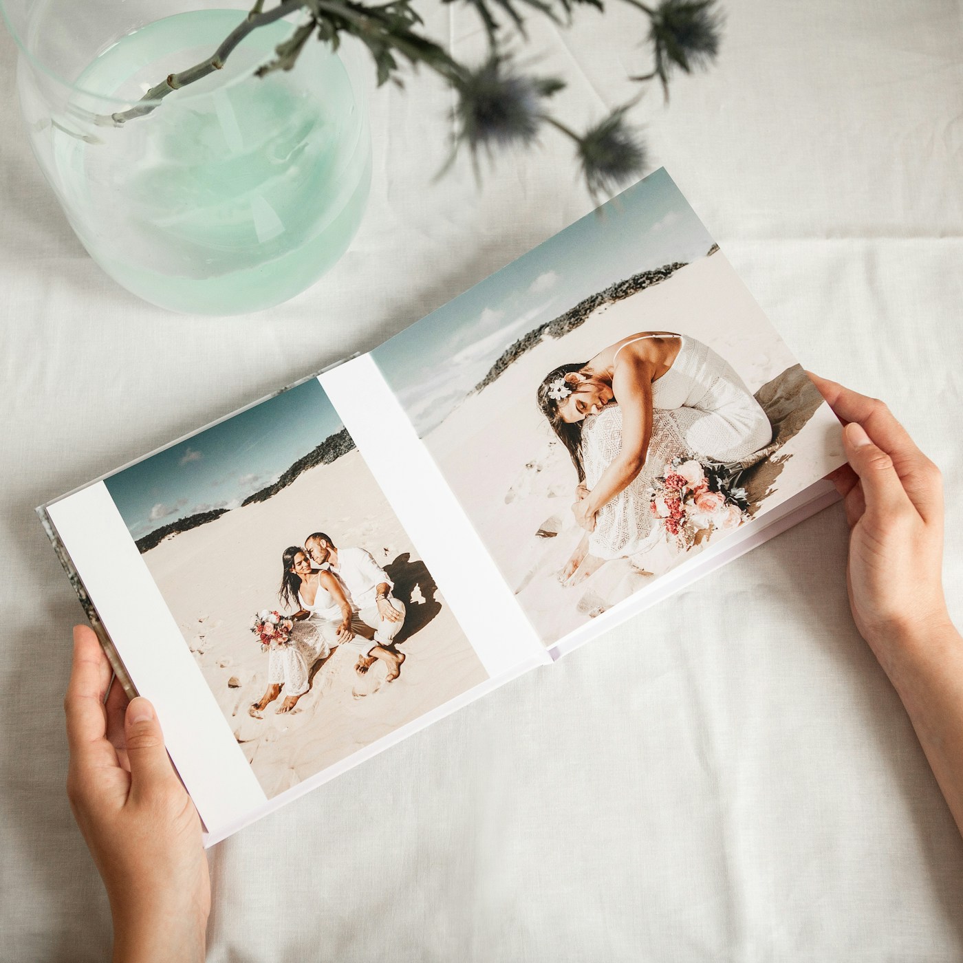 Hands holding an open wedding photo book