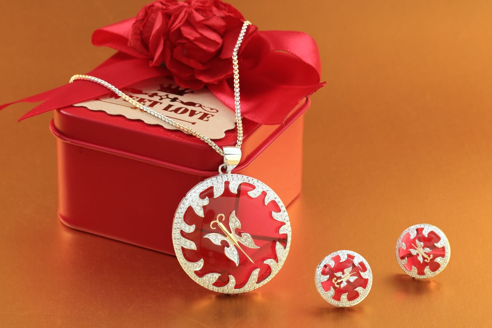 Jewellery presented beside a small red gift box